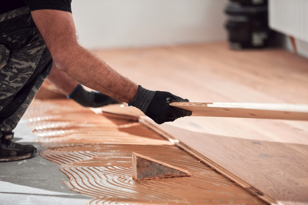 Wood flooring being fitted over adhesive